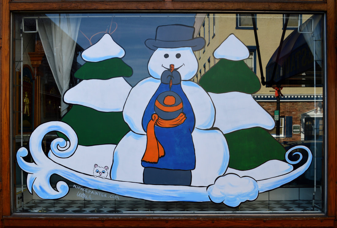 Winter Window Art Featuring a Child Giving a Snowman its Carrot Nose, in Newton, Sussex County, NJ
