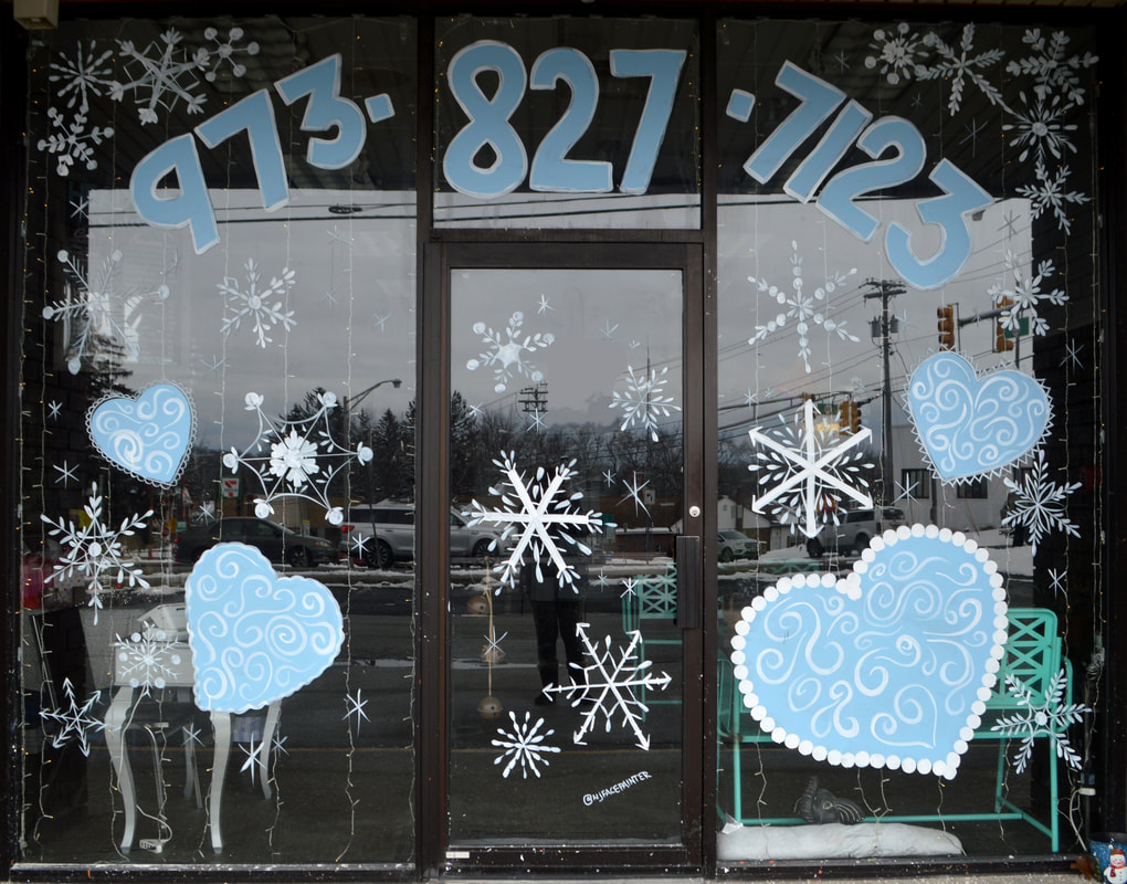 Winter Window Painting at Headz Up Hair Salon in Hamburg, Sussex County, NJ featuring blue hearts and white snowflakes