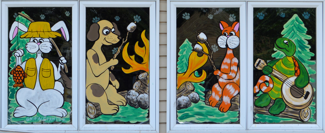 Summer Window Art at Maywood Veterinary Hospital in Maywood, Bergen County, NJ featuring a rabbit, dog, cat, and tortoise camping