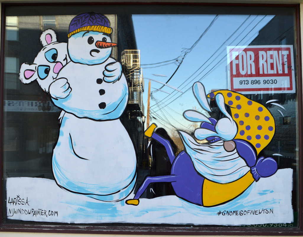 Winter Window Painting in Newton, Sussex County, NJ featuring a Polar Bear Hitting a Gnome with a Snowball