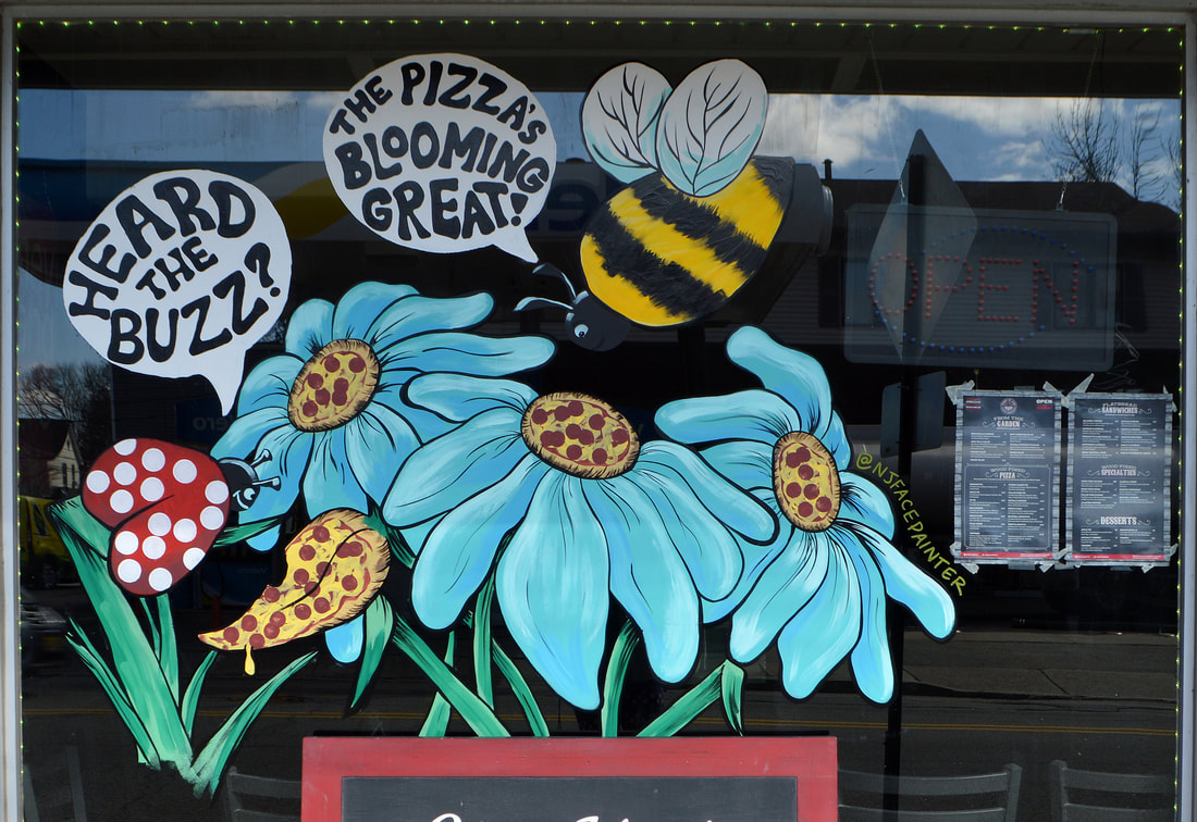 Spring Window Painting at Coney Island Pizza in Riverdale, Passaic County, NJ featuring a ladybug and bee eating pizza daisies
