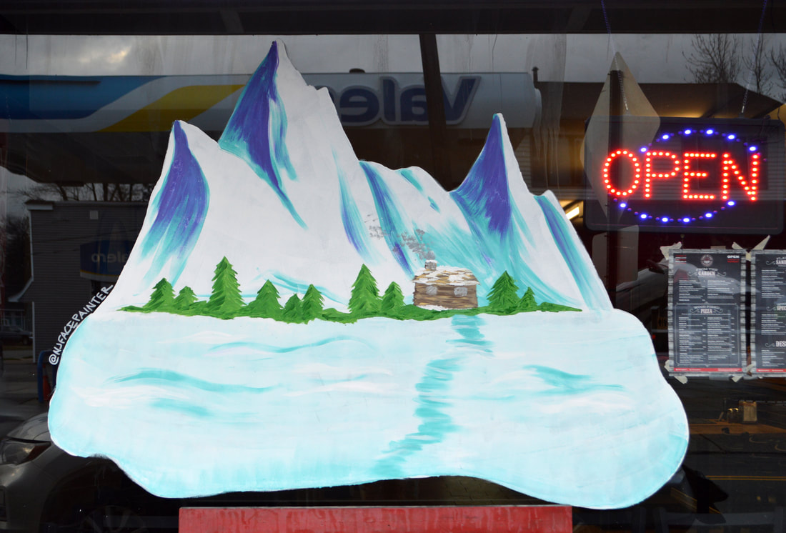 Winter Window Art at Coney Island Pizza in Riverdale, Passaic County, NJ featuring snowy mountains, trees, and a cabin
