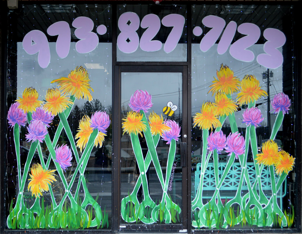 Spring Windows at Headz Up Hair Salon in Hamburg, Sussex County, NJ featuring clovers and dandelions