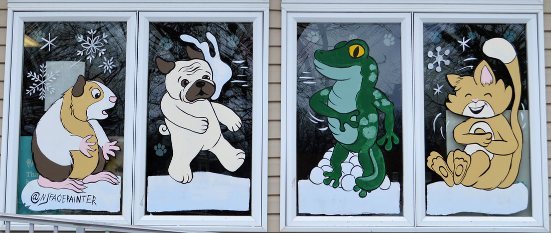 Winter Window Painting at Maywood Vet in Maywood, Bergen County, NJ featuring a guinea pig, pug dog, gecko lizard, and cat having a snowball fight