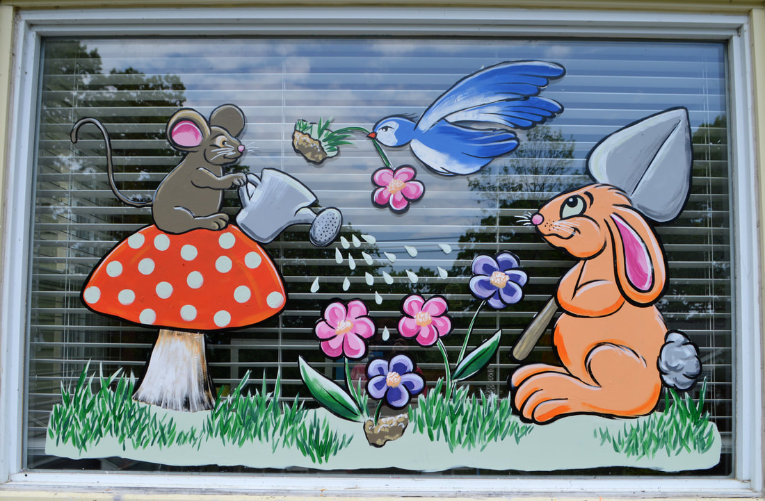 Spring Residential Window Painting in Wayne, Passaic County, NJ featuring a mouse, bird, and rabbit planting flowers