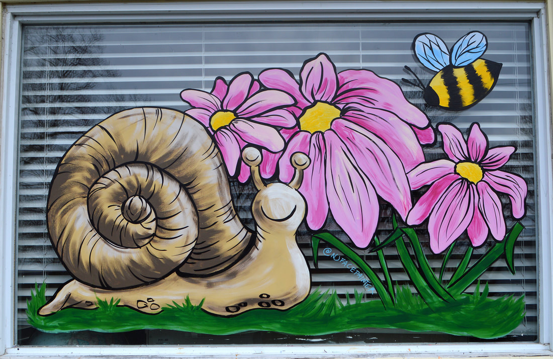 Spring Residential Window Painting in Wayne, Passaic County, NJ featurign a snail, pink daisies, and a bee
